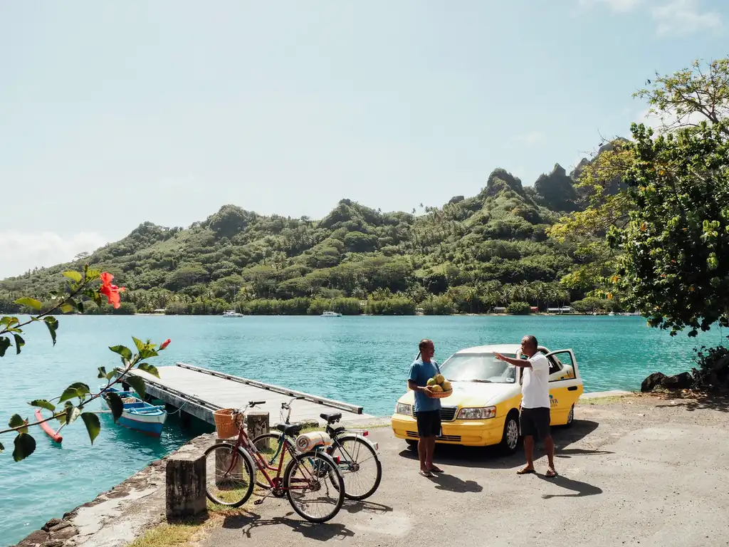 Taxis and bicycles parked near the harbour in Moorea, ready for port day transport