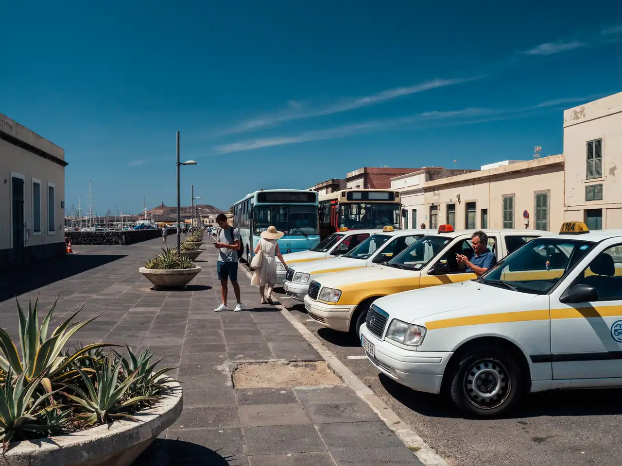 Taxis and buses lined up near the harbour in Arrecife, Lanzarote, under a sunny sky
