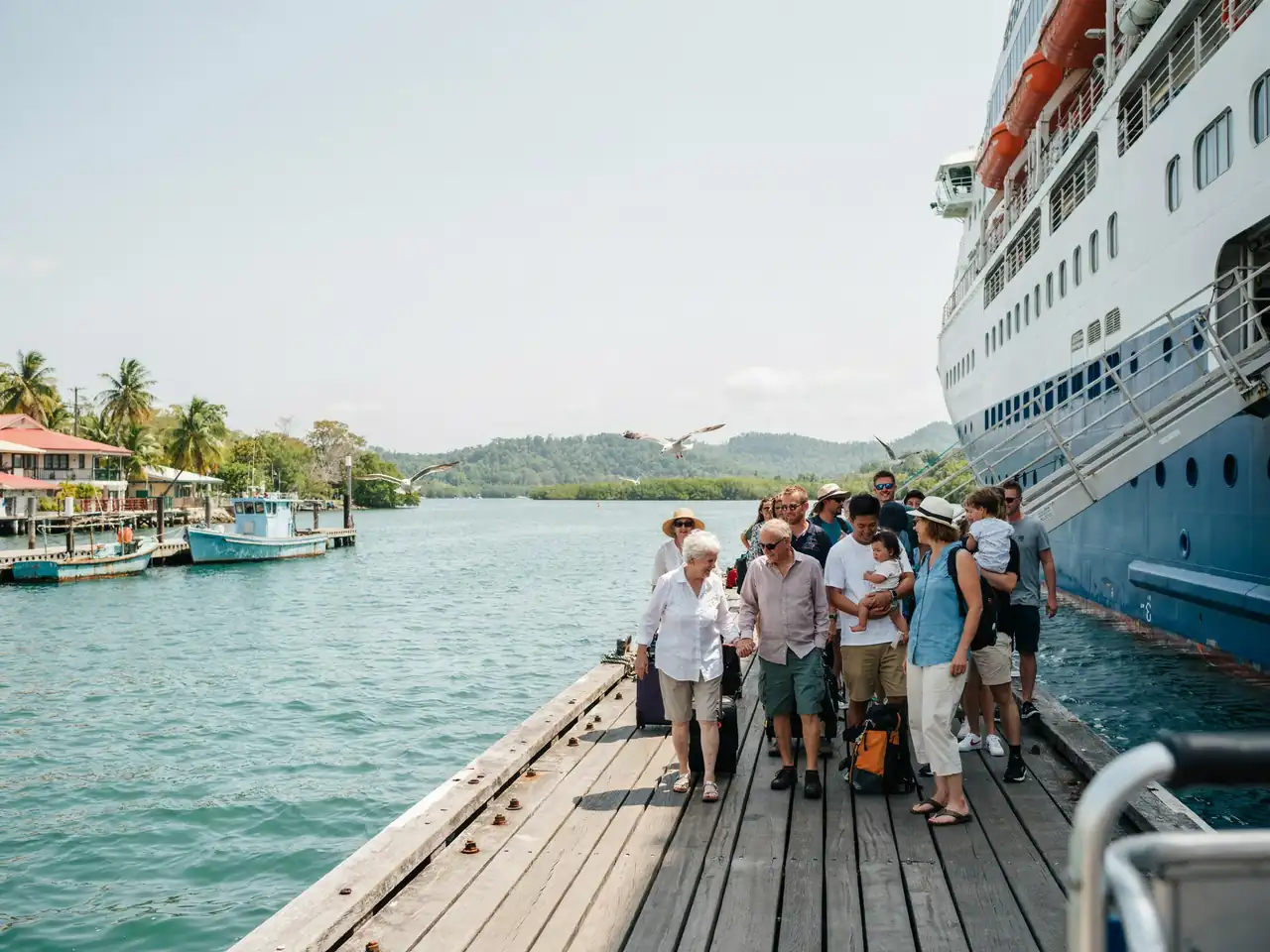 Cruise passengers disembarking at Port Douglas harbour on a sunny day