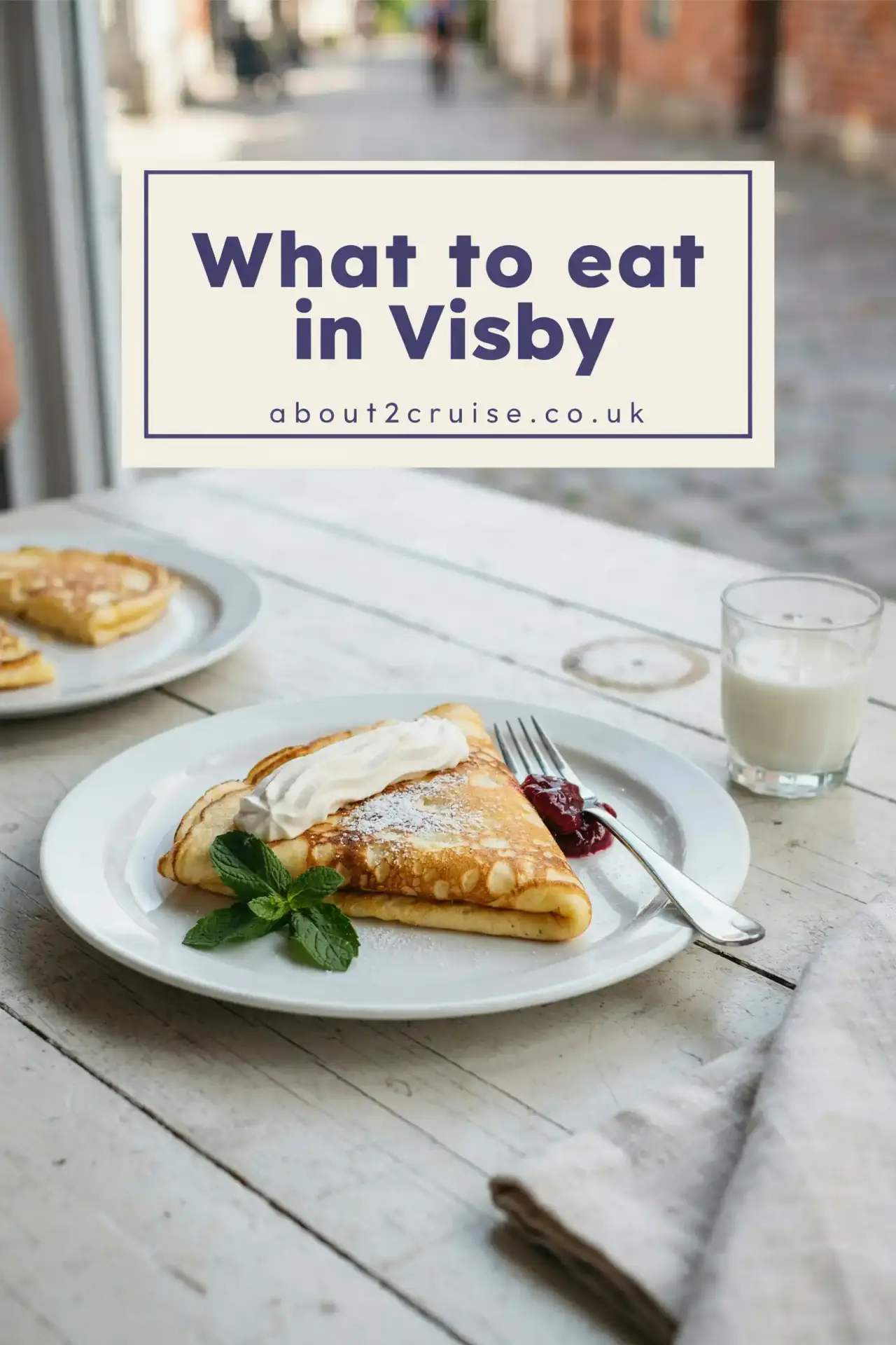 Visby cruise port: saffron pancake with dewberry jam and whipped cream at a sunny cafe table